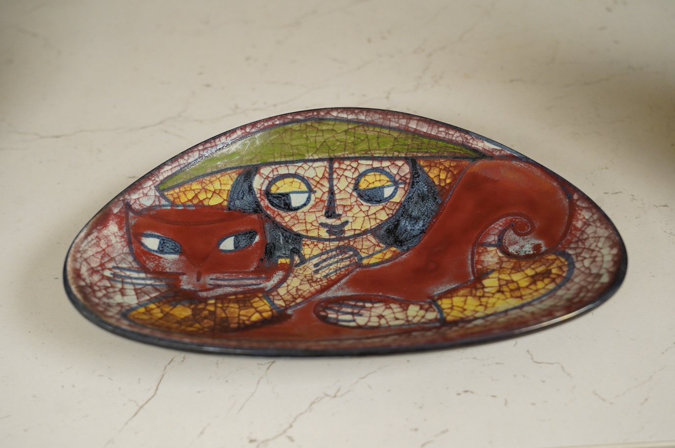 A Michael Andersen lustre stylised 'girl hugging a cat' dish, 20.5cm wide. Condition - good